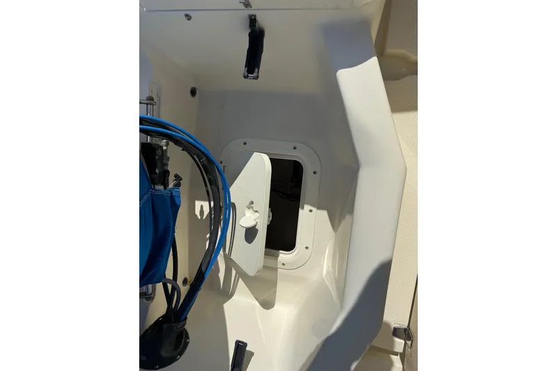 Slide: The Image of Interior view of a 2004 Holby Pilot 19 boat showing storage compartment. - 6