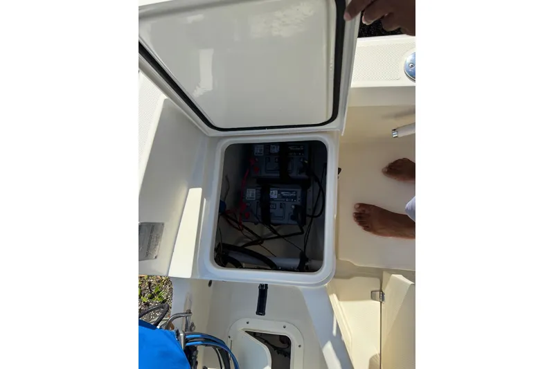 Slide: The Image of Open battery compartment on 2004 Holby Pilot 19 boat, showing wiring and connections. - 9