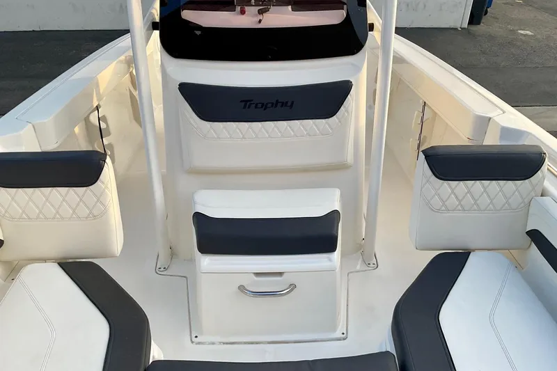 Slide: The Image of 2021 Bayliner Trophy T20CC boat interior with cushioned seating and storage. - 10