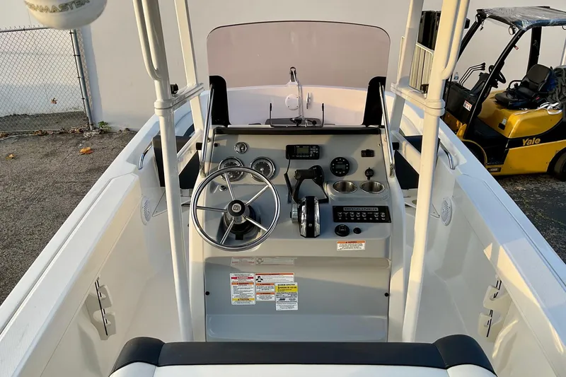 Slide: The Image of 2021 Bayliner Trophy T20CC boat console with steering wheel and controls. - 12