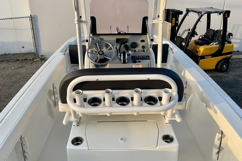Slide: The Image of 2021 Bayliner Trophy T20CC boat interior with steering console and rod holders. - 13