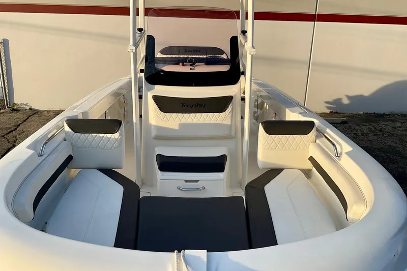 Slide: The Image of 2021 Bayliner Trophy T20CC boat interior with cushioned seating and modern design. - 14