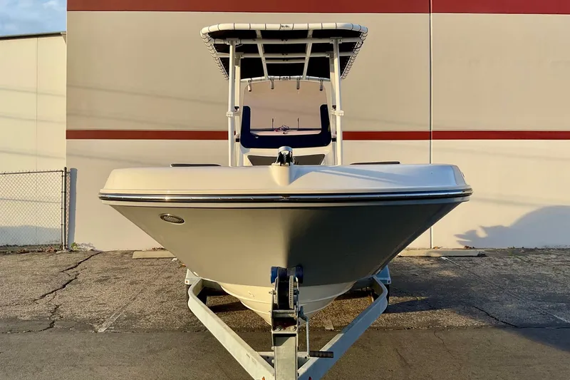Slide: The Image of 2021 Bayliner Trophy T20CC boat on trailer, front view, parked outdoors. - 15