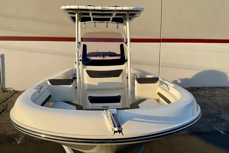 Slide: The Image of 2021 Bayliner Trophy T20CC boat with T-top and seating, docked outdoors. - 5