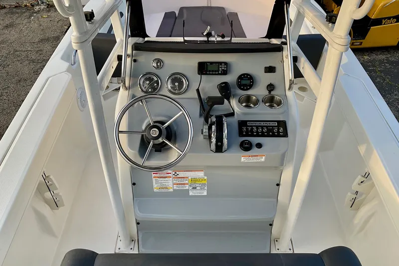 Slide: The Image of 2021 Bayliner Trophy T20CC boat console with steering wheel and controls. - 7