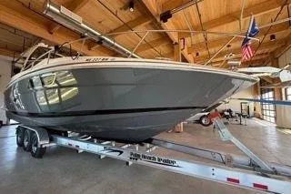 Slide: The Image of 2019 Regal 35 Sport Coupe boat on trailer in wooden interior setting. - 2