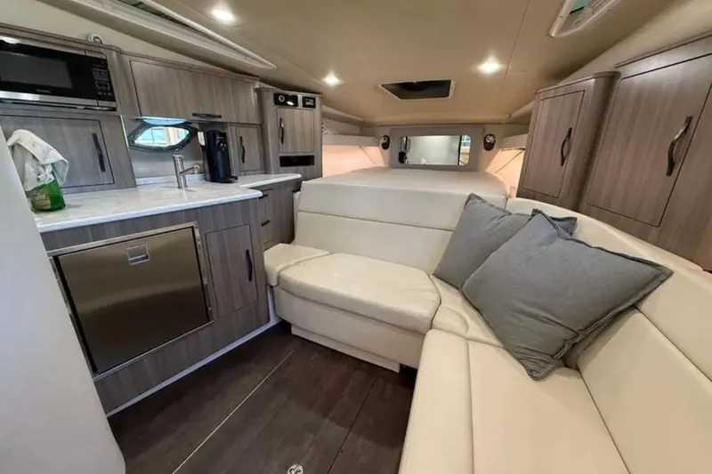 Slide: The Image of 2019 Regal 35 Sport Coupe interior with modern kitchen and cozy seating area. - 20
