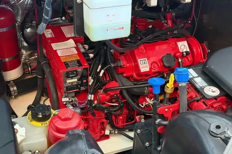 Slide: The Image of Engine compartment of a 2019 Regal 35 Sport Coupe with red components and wiring. - 24