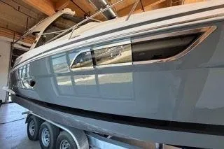 Slide: The Image of 2019 Regal 35 Sport Coupe boat on trailer in indoor storage. - 5
