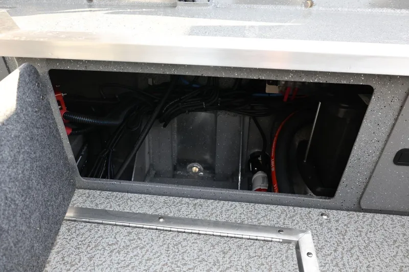 Slide: The Image of Interior compartment of 2026 Thunder Jet 209 Rush OT boat, showing wiring and components. - 21