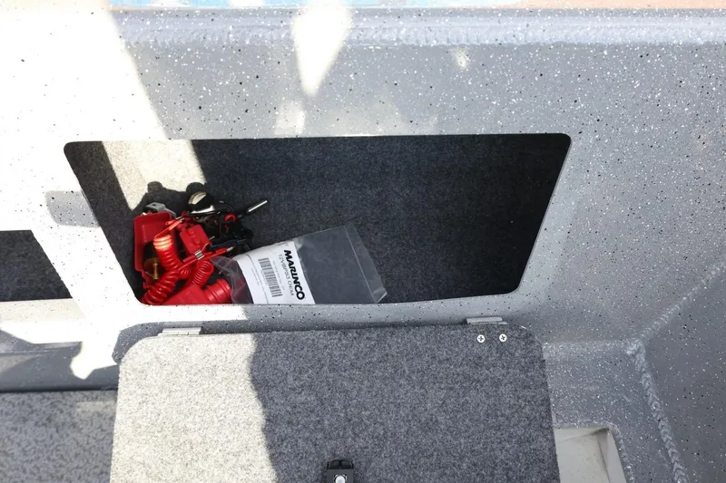 Slide: The Image of Storage compartment in 2026 Thunder Jet 209 Rush OT boat with safety gear and accessories. - 24