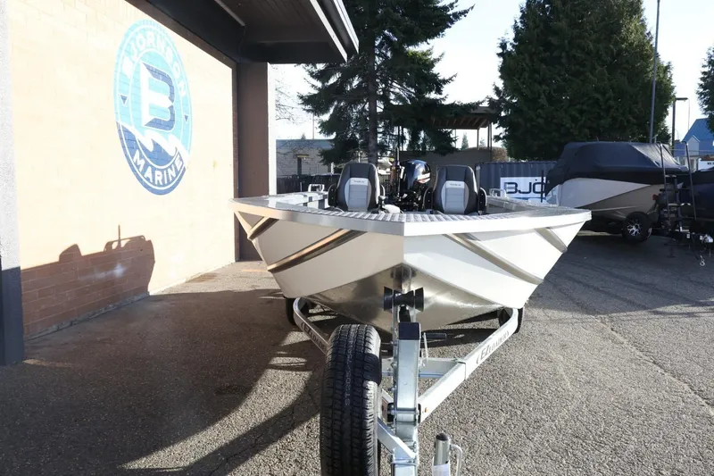 Slide: The Image of 2026 Thunder Jet 209 Rush OT boat on trailer at dealership. - 3