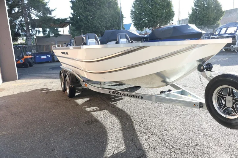 Slide: The Image of 2026 Thunder Jet 209 Rush OT boat on EZ Loader trailer in outdoor setting. - 4