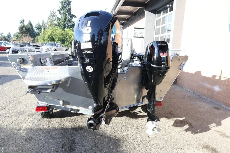 Slide: The Image of 2026 Thunder Jet 209 Rush OT boat with dual Mercury outboard motors, parked outdoors. - 6
