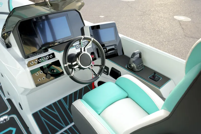 Slide: The Image of Cockpit of 2026 Paradigm 266 SL SURF boat with modern controls and teal seating. - 8