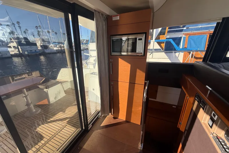 Slide: The Image of Interior of 2016 Prestige 450S yacht with wooden cabinetry and marina view. - 15