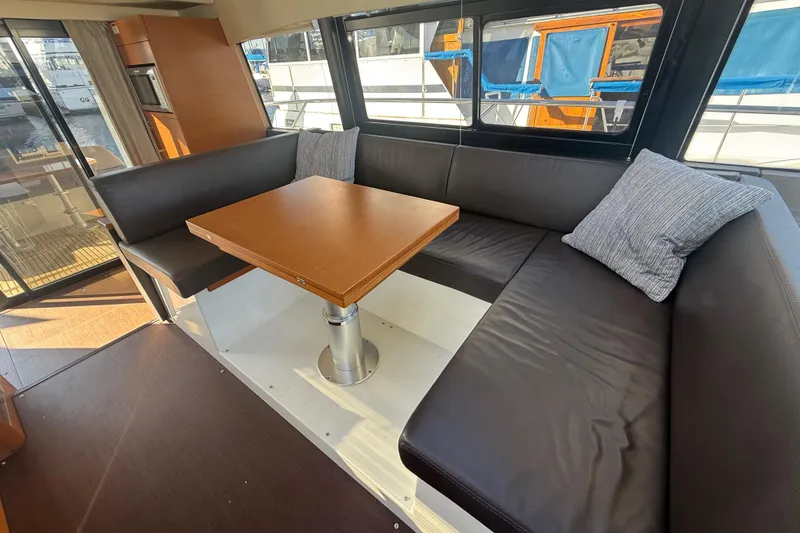 Slide: The Image of Luxurious interior of 2016 Prestige 450S yacht with leather seating and wooden table. - 16