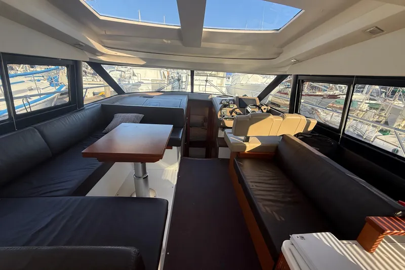 Slide: The Image of Luxurious interior of a 2016 Prestige 450S yacht with spacious seating and helm. - 17