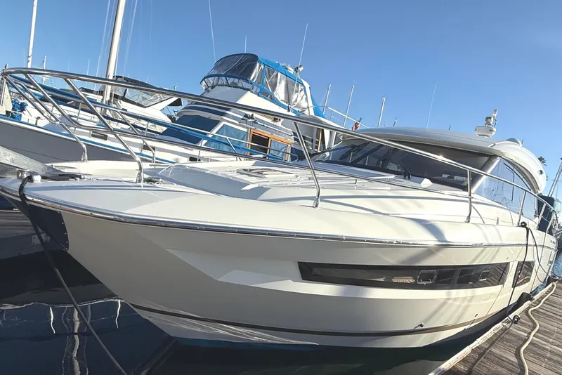 Slide: The Image of 2016 Prestige 450S yacht docked at marina under clear blue sky. - 2