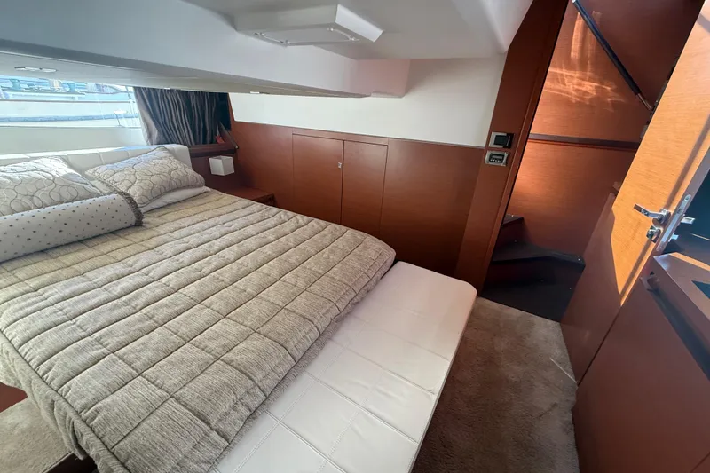 Slide: The Image of Luxurious bedroom interior of 2016 Prestige 450S yacht with cozy bedding and wooden accents. - 20