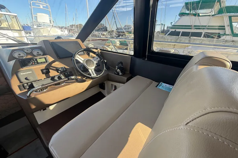Slide: The Image of Interior cockpit of 2016 Prestige 450S yacht with steering wheel and navigation controls. - 28