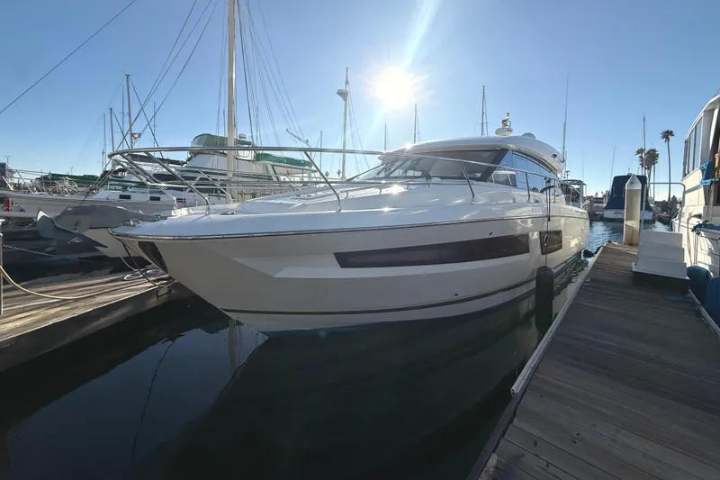 Slide: The Image of 2016 Prestige 450S yacht docked in marina under bright sun. - 3