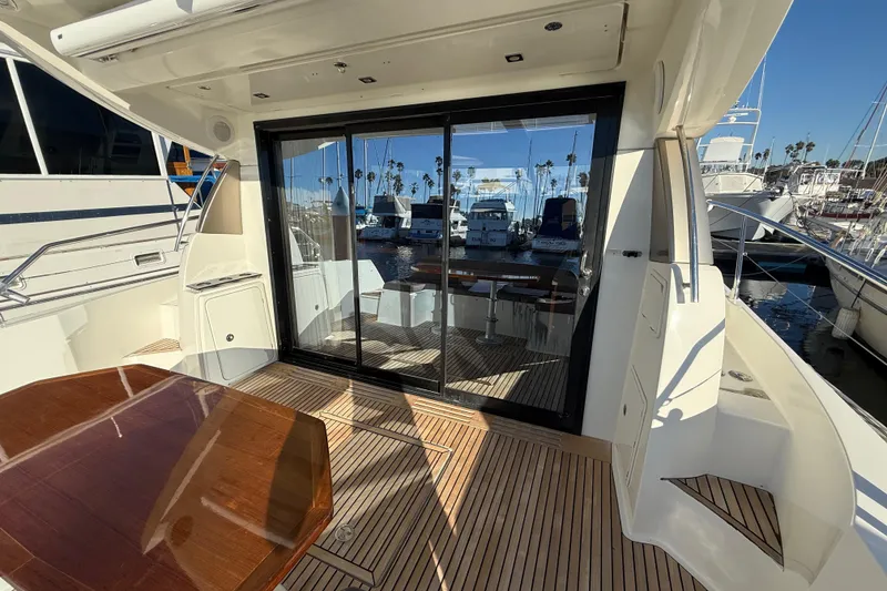 Slide: The Image of Luxury yacht deck of 2016 Prestige 450S with glass doors and wooden table. - 8