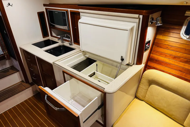 Slide: The Image of 2015 MJM 36z Express yacht interior with modern kitchen and wooden accents. - 13
