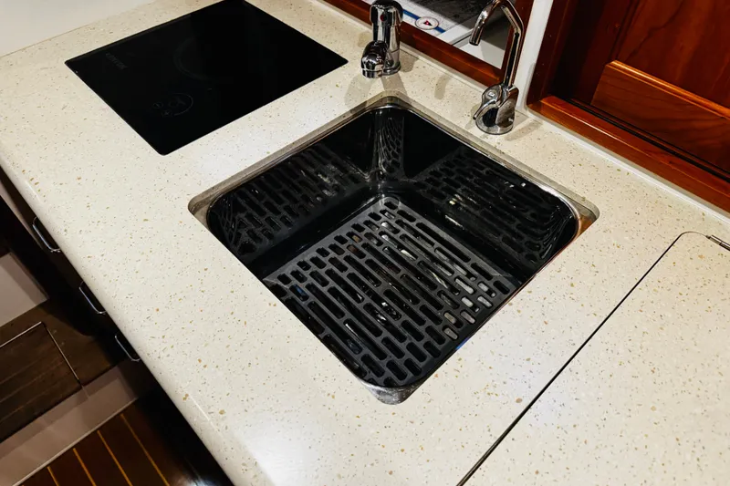 Slide: The Image of Modern kitchen sink and stovetop in 2015 MJM 36z Express yacht. - 15