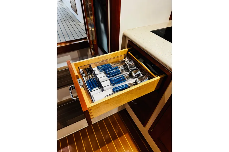Slide: The Image of Open drawer with blue-handled cutlery on 2015 MJM 36z Express yacht. - 17