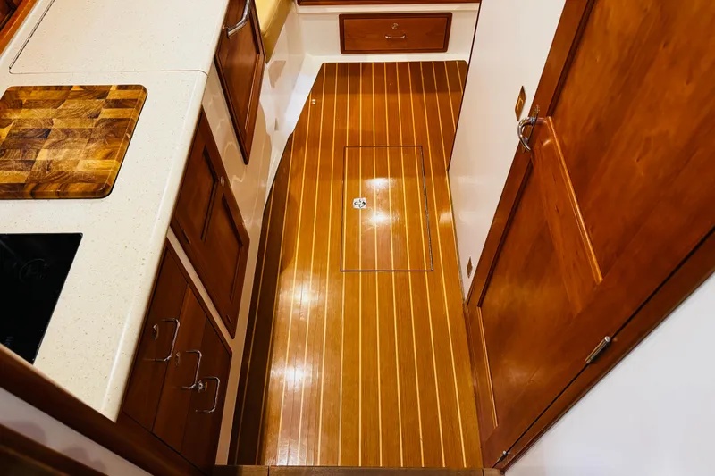 Slide: The Image of 2015 MJM 36z Express yacht interior with wooden flooring and cabinetry. - 18