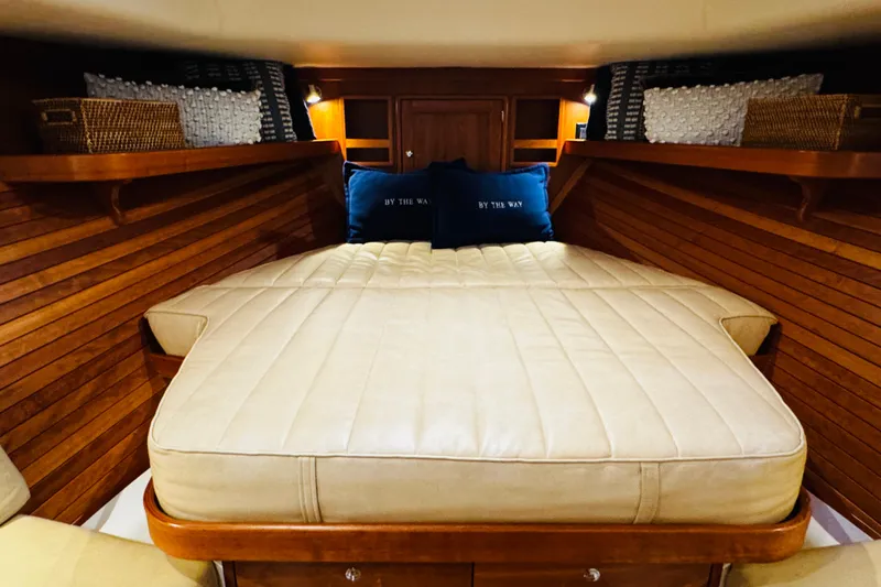Slide: The Image of Luxurious cabin interior of 2015 MJM 36z Express with cozy bedding and wooden accents. - 2