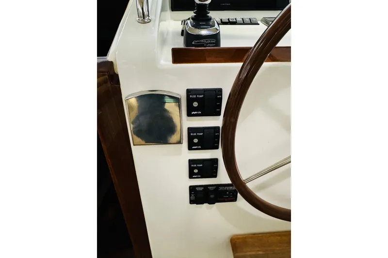 Slide: The Image of Control panel of 2015 MJM 36z Express boat with steering wheel and switches. - 25