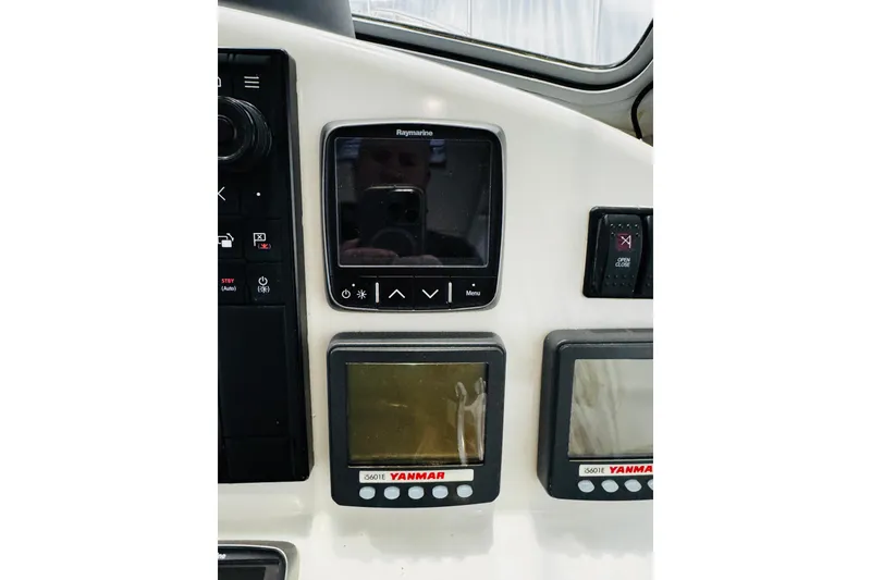 Slide: The Image of Control panel of a 2015 MJM 36z Express boat with Raymarine and Yanmar displays. - 26
