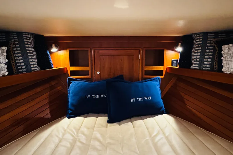 Slide: The Image of Cozy cabin interior of 2015 MJM 36z Express with blue pillows and wooden accents. - 3