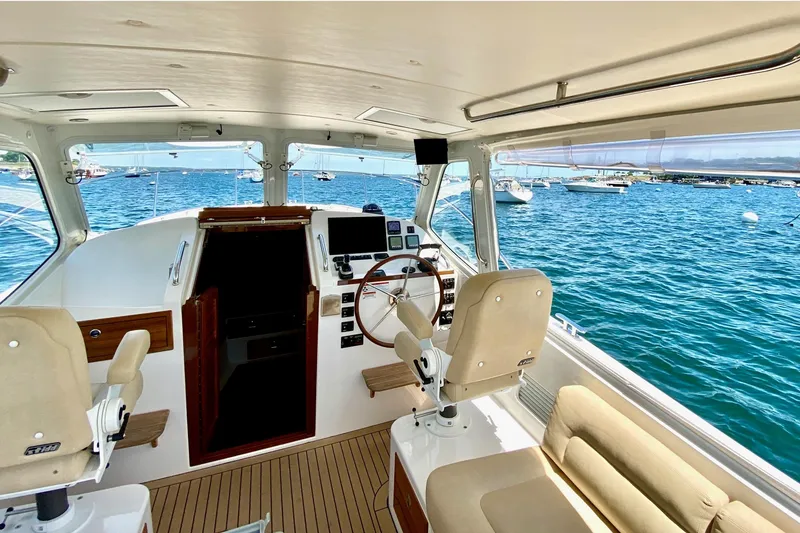 Slide: The Image of Interior view of 2015 MJM 36z Express yacht with helm and seating, overlooking ocean. - 32