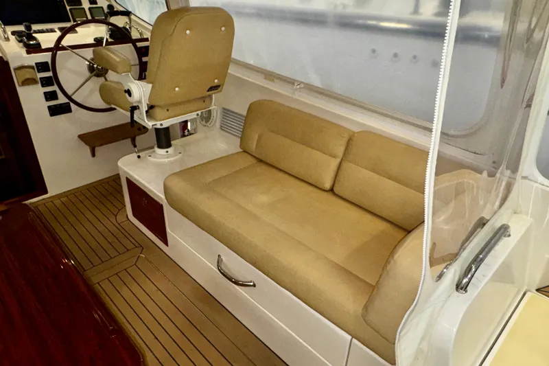 Slide: The Image of Interior of 2015 MJM 36z Express boat with beige seating and steering wheel. - 35