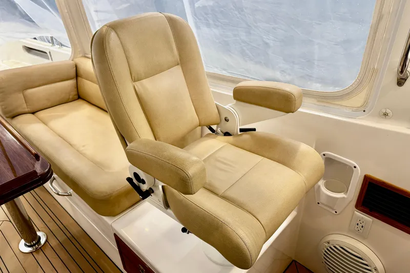 Slide: The Image of Captain's chair and seating area on 2015 MJM 36z Express boat interior. - 36