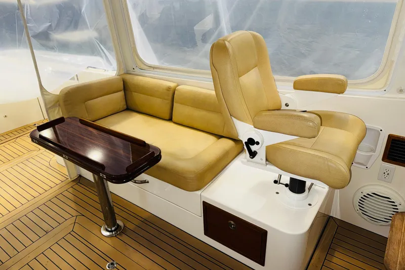 Slide: The Image of Interior of 2015 MJM 36z Express with tan seating and wooden table. - 38