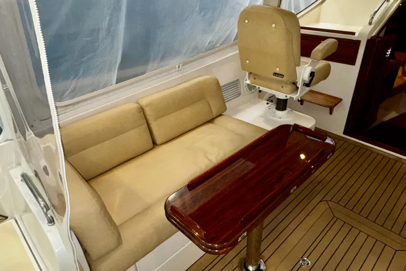 Slide: The Image of 2015 MJM 36z Express yacht interior with beige seating and polished wood table. - 40