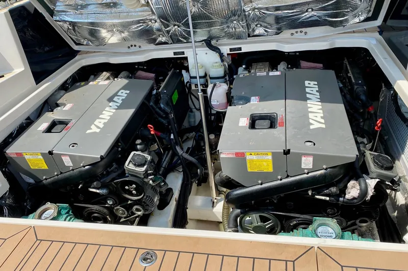 Slide: The Image of Twin Yanmar engines in a 2015 MJM 36z Express boat, showcasing engine compartment. - 43