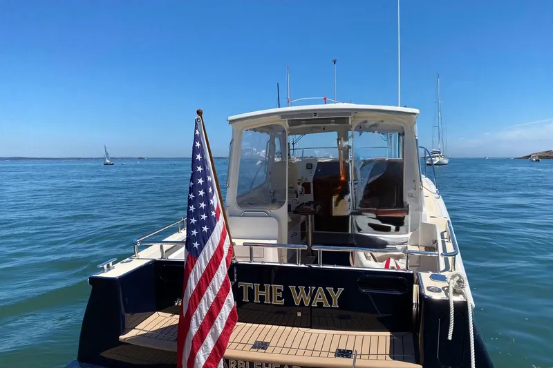 Slide: The Image of 2015 MJM 36z Express yacht with American flag on calm sea. - 49