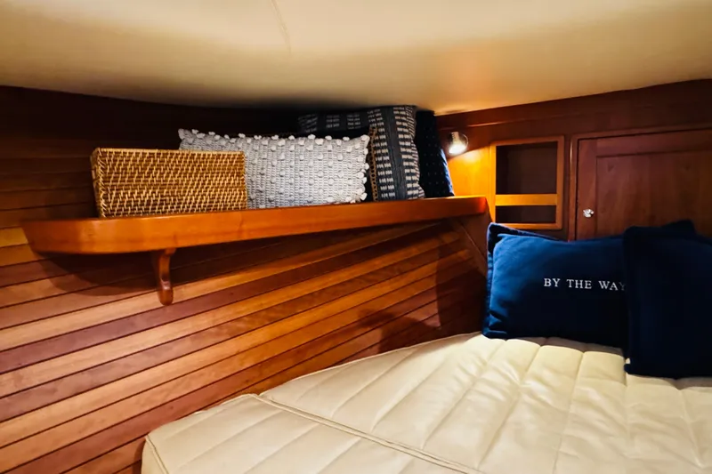Slide: The Image of Cozy cabin interior of 2015 MJM 36z Express with wooden paneling and decorative pillows. - 6