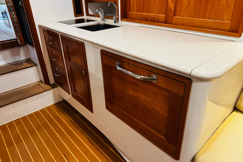Slide: The Image of Luxurious galley interior of 2015 MJM 36z Express yacht with wooden cabinetry and modern sink. - 9