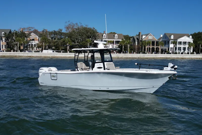 The Image of 2025 Sea Hunt Gamefish 30 Coffin Box boat on water, with waterfront homes in background. - 0