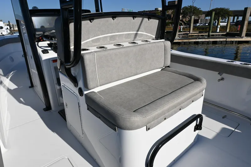 Slide: The Image of 2025 Sea Hunt Gamefish 30 Coffin Box boat interior with cushioned seating and control panel. - 10