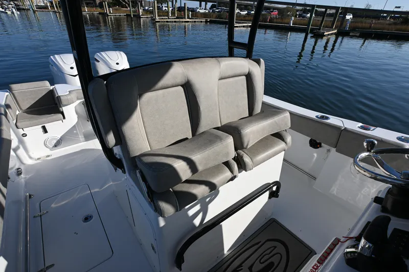 Slide: The Image of 2025 Sea Hunt Gamefish 30 Coffin Box boat interior with cushioned seating and steering wheel. - 13