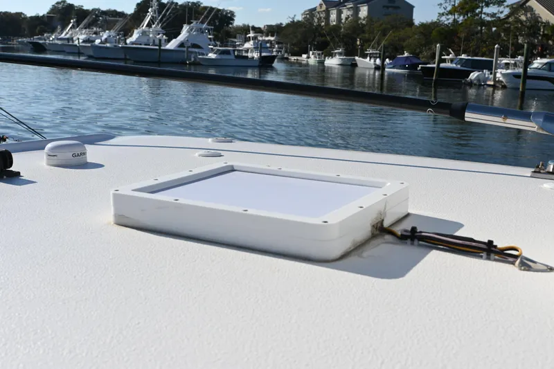 Slide: The Image of 2025 Sea Hunt Gamefish 30 Coffin Box on calm marina waters. - 19