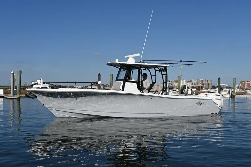 Slide: The Image of 2025 Sea Hunt Gamefish 30 Coffin Box boat on calm water, clear sky background. - 4