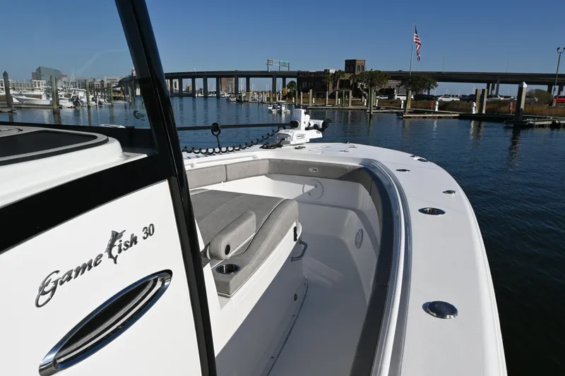 Slide: The Image of 2025 Sea Hunt Gamefish 30 Coffin Box boat docked in a marina, clear sky. - 9